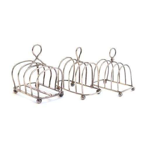 94 - Three silver toast racks: the largest, four division, by Mappin & Webb, London 1919; the other two B... 