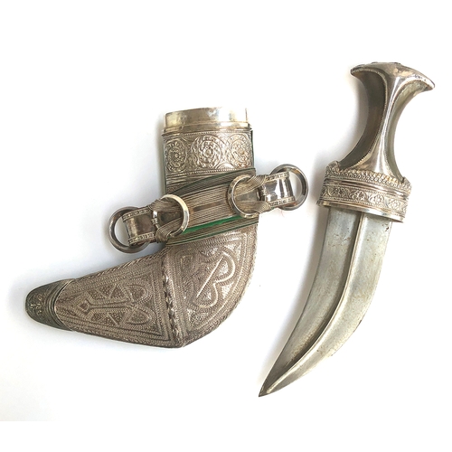 245 - An Omani white Khanjar knife, with worked white metal sheath, the curved blade with white metal and ... 