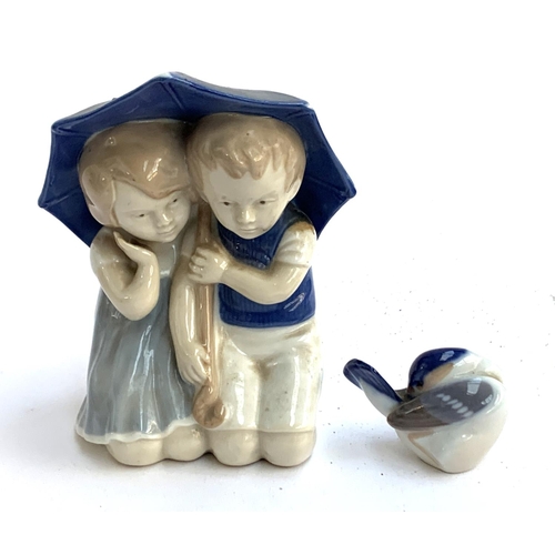 125 - A Carl Schneider Erben porcelain figure of two children underneath an umbrella, 12.5cmH; together wi... 