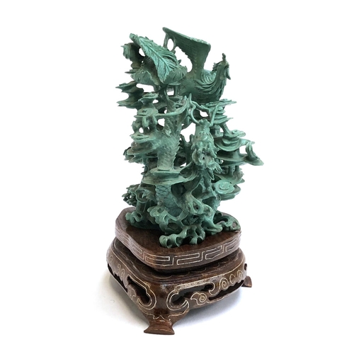 138 - A 20th century Chinese turquoise resin figure of a dragon and phoenix amongst swirling clouds on a h... 