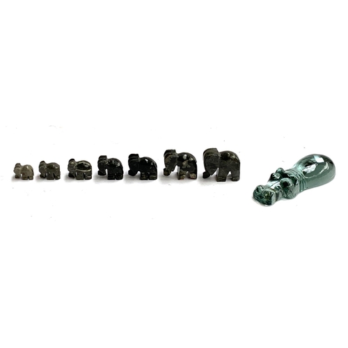 151 - A set of seven small graduating soapstone elephants, the tallest 4cmH; together with a glass 'swimmi... 