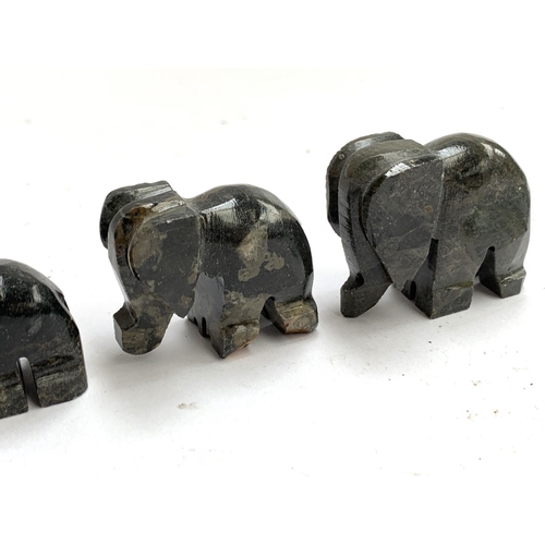 151 - A set of seven small graduating soapstone elephants, the tallest 4cmH; together with a glass 'swimmi... 