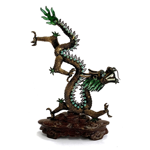 290 - A Chinese bronze and enamel dragon figurine, set with turquoise coloured cabochons, on carved wooden... 