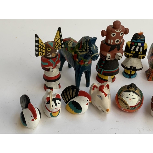 294 - Japanese ceramic zodiac whistles; ceramic bells; South American painted wooden figures inc. Mudherd ... 