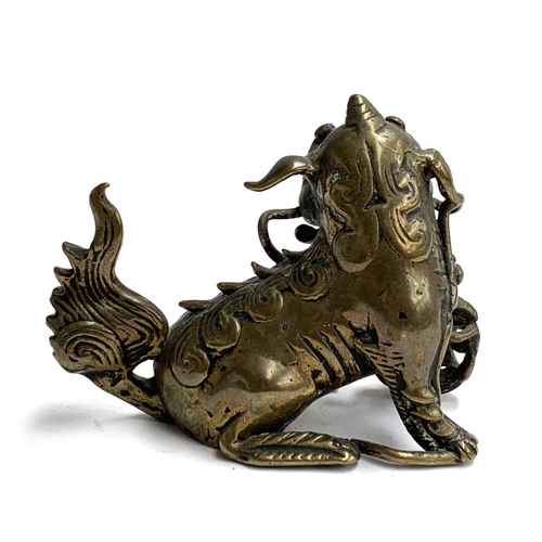 357 - A Chinese bronze foo dog holding a ball beneath paw, 7cmH