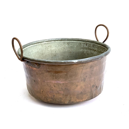 1020 - A twin handled copper vessel, 42cmD