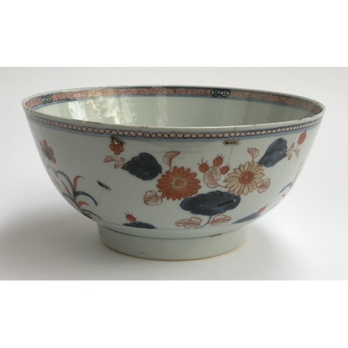 202 - A 19th century Chinese export bowl, with staple pairs, floral decoration in orange and blue, 23cmD