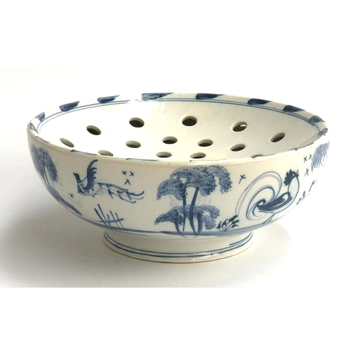 214 - Interior interest: A Deborah Sears Isis ceramics strainer bowl, hand painted with birds in a landsca... 