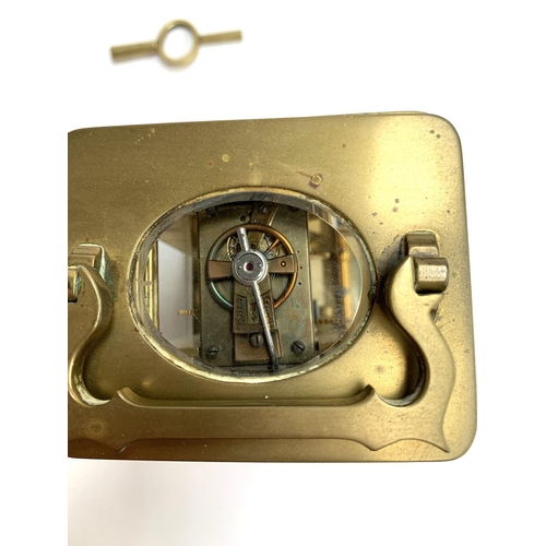 94 - A brass carriage clock with bevelled glass and enamel dial with Roman numerals, 11cmH, with key