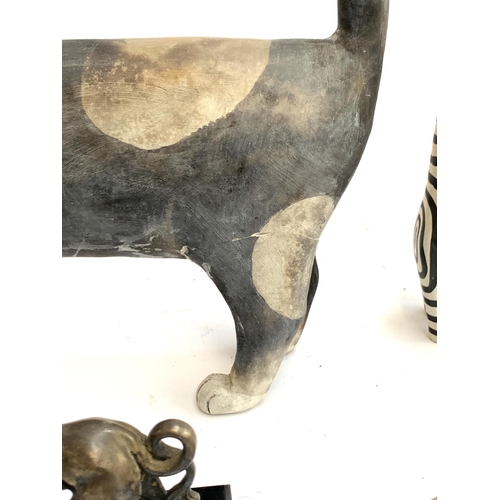 449 - A large studio pottery cat (leg repaired), 33cmL; together with a pair of wooden cats; a resin Griff... 