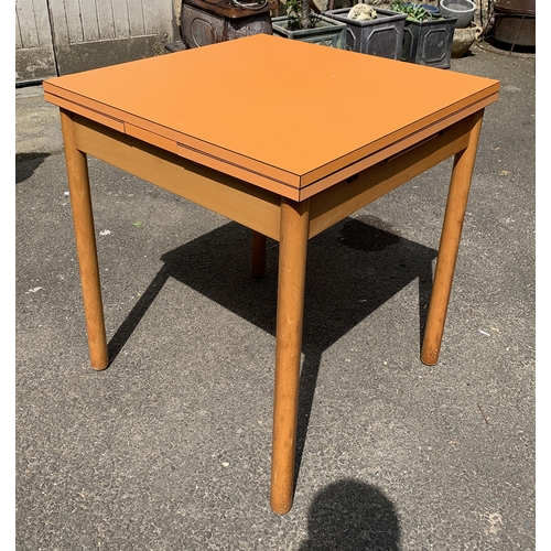 988 - A mid century orange formica topped extending kitchen table, 68x68x76cmH, each leaf an additional 26... 