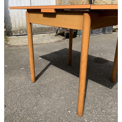 988 - A mid century orange formica topped extending kitchen table, 68x68x76cmH, each leaf an additional 26... 