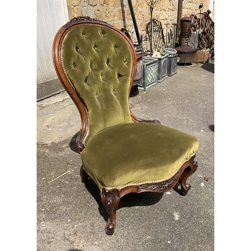 993 - A Victorian buttonback bedroom chair with carved walnut frame and ceramic casters