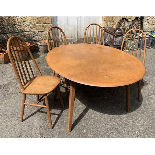 997 - A set of four beech and oak hoopback Ercol style kitchen chairs; together with a matching dropleaf t... 