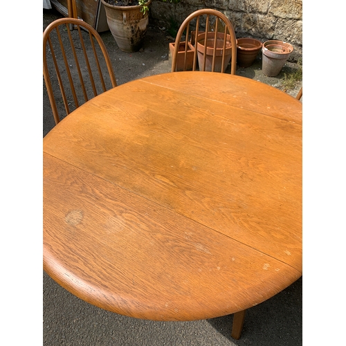 997 - A set of four beech and oak hoopback Ercol style kitchen chairs; together with a matching dropleaf t... 