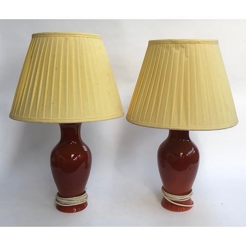 985 - A pair of brick glazed baluster form table lamps with yellow pleated shades, 65cmH to top of shade