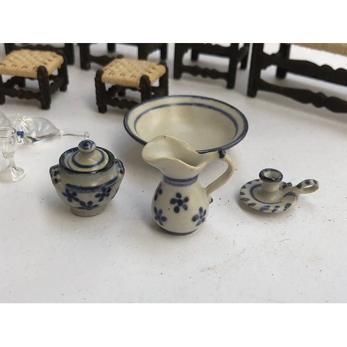 233 - A quantity of dolls house furniture to include hand blown glass dinner service; blue and white ceram... 