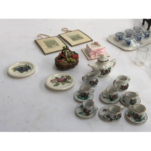 233 - A quantity of dolls house furniture to include hand blown glass dinner service; blue and white ceram... 