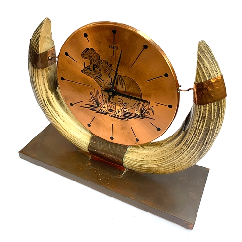 384 - A vintage German Kienzle copper and resin horn mantle clock decorated with an image of a hippo, 34cm... 