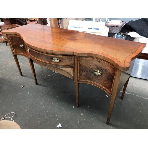 1029 - A substantial Georgian revival mahogany crossbanded serpentine sideboard, central drawer with well b... 