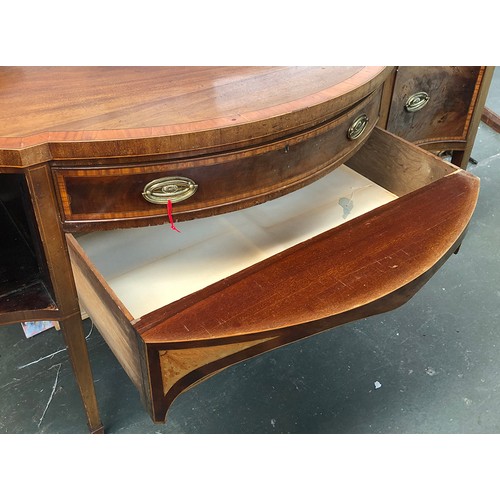 1029 - A substantial Georgian revival mahogany crossbanded serpentine sideboard, central drawer with well b... 