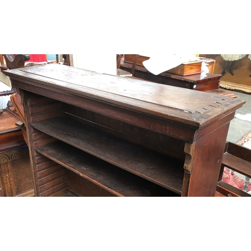 1036 - An oak bookcase, moulded cornice over adjustable shelves, on cabriole legs