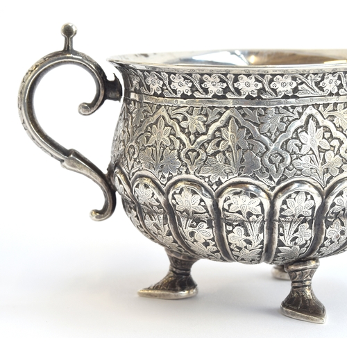 105 - An Indian silver twin handled sugar bowl, the half gadrooned body allover chased with foliate design... 