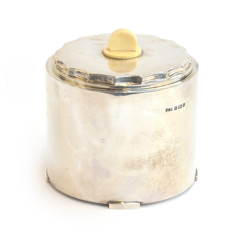 115 - An Art Deco silver biscuit barrel by Hukin & Heath Ltd, Birmingham 1932, of cylindrical form on four... 