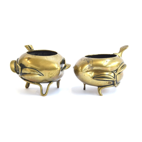 192 - Two Chinese late 19th century gilt bronze peach censers, each raised on three feet modelled as vines... 