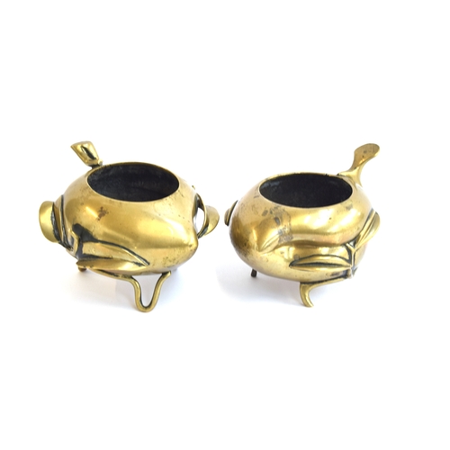 192 - Two Chinese late 19th century gilt bronze peach censers, each raised on three feet modelled as vines... 