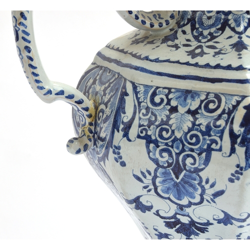 210 - An 18th century large Delft twin handled urn with cover, decorated with swirling florals, marked to ... 