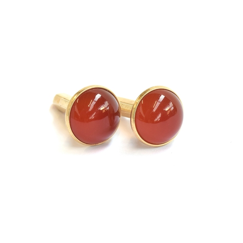 23 - A pair of 10ct gold cufflinks set with carnelian cabochons, 1.3cm diameter, marked '10k Diana', gros... 