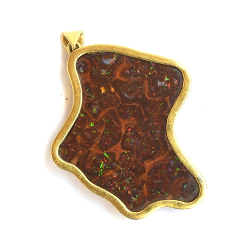 29 - A large boulder opal pendant mounted in gold, tests as 18ct, 16.9g