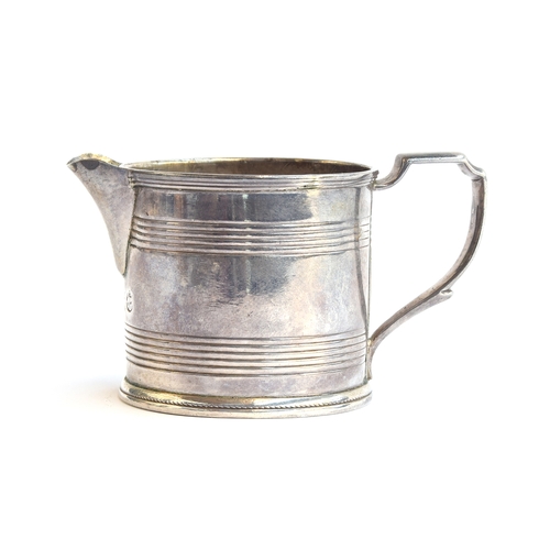 103 - A Georgian silver milk jug, marks rubbed, cylindrical banded body, 5.5cm high, 2.6ozt