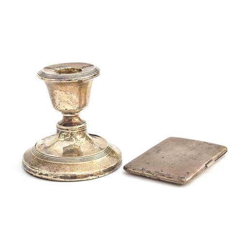 145 - An Edwardian loaded silver dwarf candlestick, 8cm high; together with a George V engine turned cigar... 