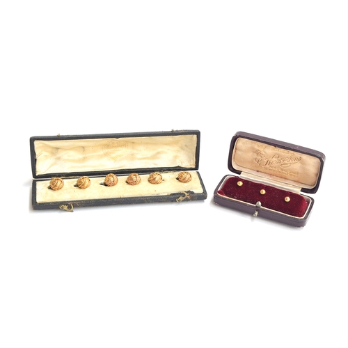 24 - A cased set of mid Victorian gold buttons, of engraved knot form, tests as 15ct or higher, gross wei... 