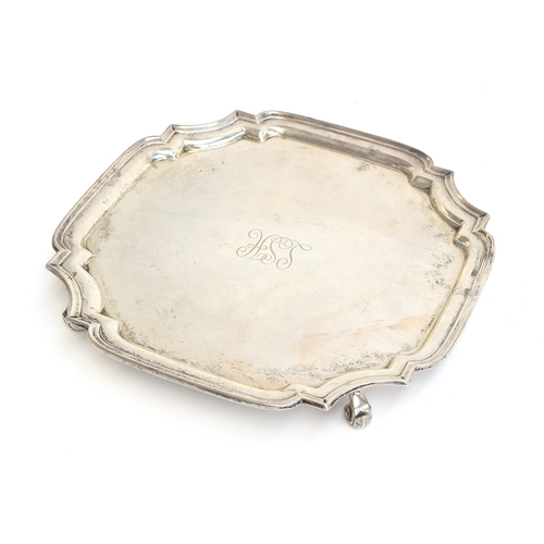 121 - A square silver salver with shaped edge, by S Blanckensee & Son Ltd, Chester 1926, on four leaf capp... 