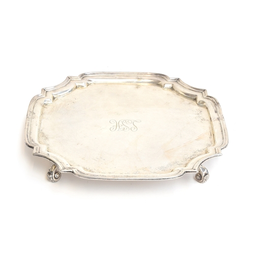 121 - A square silver salver with shaped edge, by S Blanckensee & Son Ltd, Chester 1926, on four leaf capp... 