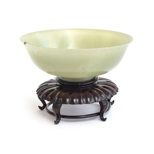 193 - A very large Chinese jade bowl, with carved Greek key border, 29cm diameter and 10.5cm high, on a ca... 