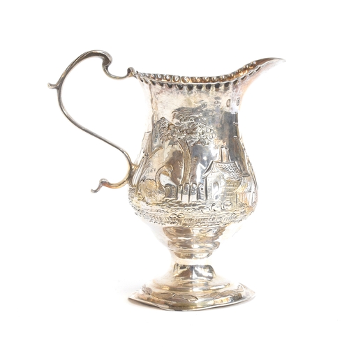 104 - A small George III silver milk jug, London 1778, chased with swan, millpond, cow and cottages, 10.5c... 