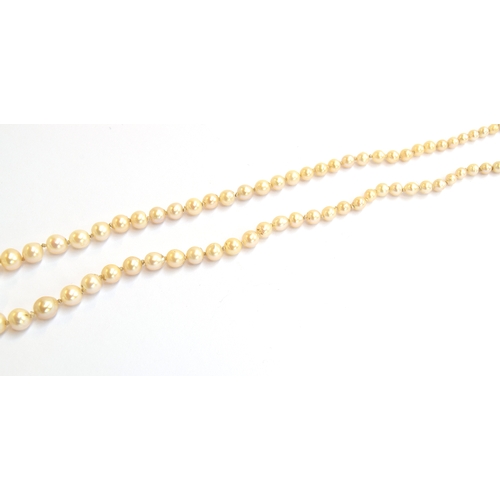15 - An early 20th century pearl necklace with rose cut diamond set clasp, 87 graduated pearls, 50cm long... 