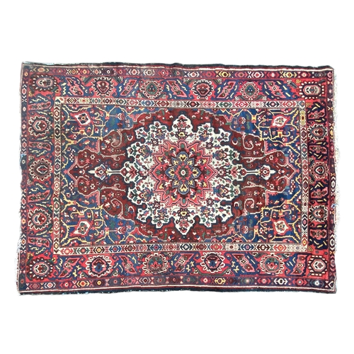 721 - A Persian Bakhtiar wool rug with central spandrel medallion, 290x210cm