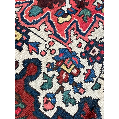 721 - A Persian Bakhtiar wool rug with central spandrel medallion, 290x210cm