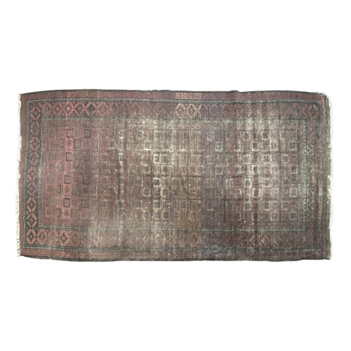 723 - A worn Persian rug with central dense geometric design, border with serrated lozenges, 160x290cm