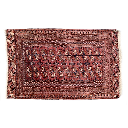 725 - A red ground tekke Turkmen rug, 180x107cm