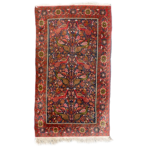 730 - A Persian Tabriz 'Tree of Life' pattern rug, birds and florals on a red ground, floral border, 102x1... 