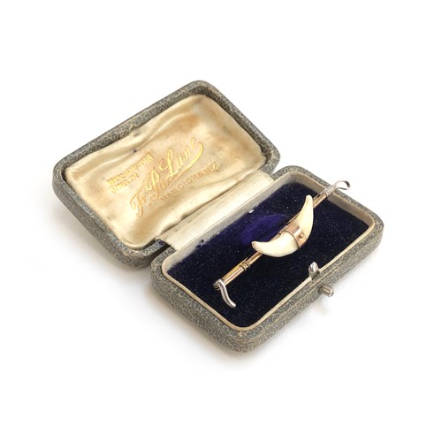 106 - An early 20th century 9ct gold and silver bar brooch in the form of a whip with mounted fox teeth, a... 