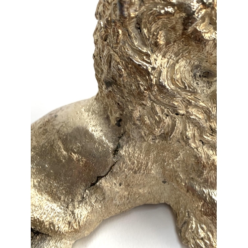40 - A filled 925 silver sculpture of a recumbent lion, 8.5cm high