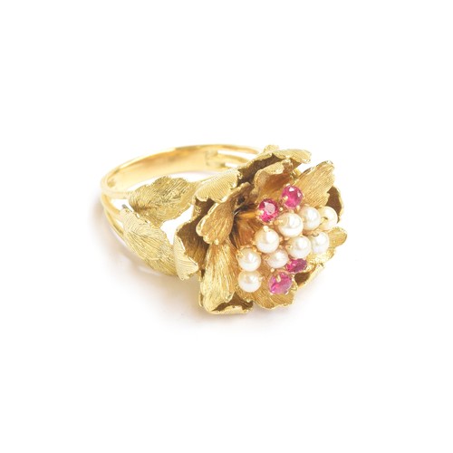 47A - A heavy 18ct gold ring in the form of a naturalistic flower head, set with a cluster of pearls and r... 