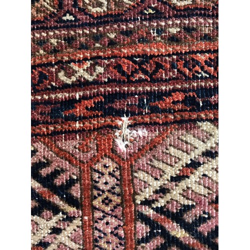 725 - A red ground tekke Turkmen rug, 180x107cm